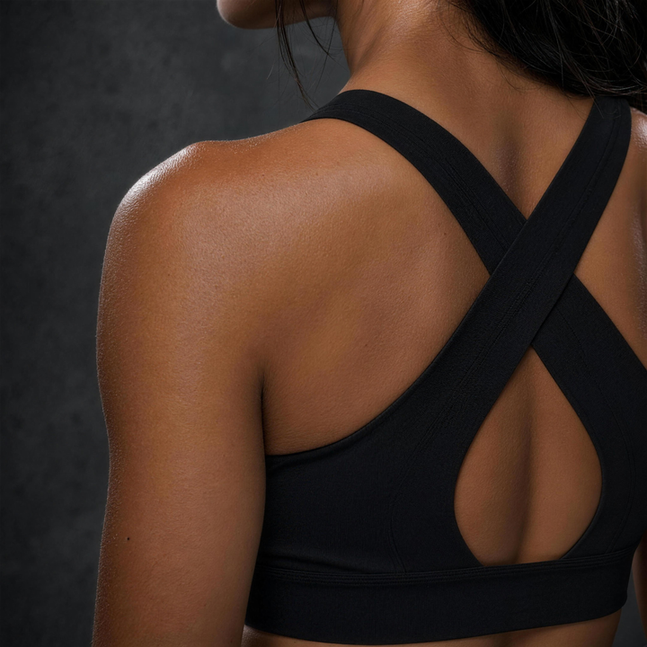 Woman wearing HIVOLT Twist Front V-Neck Sports Bra, detail closeup