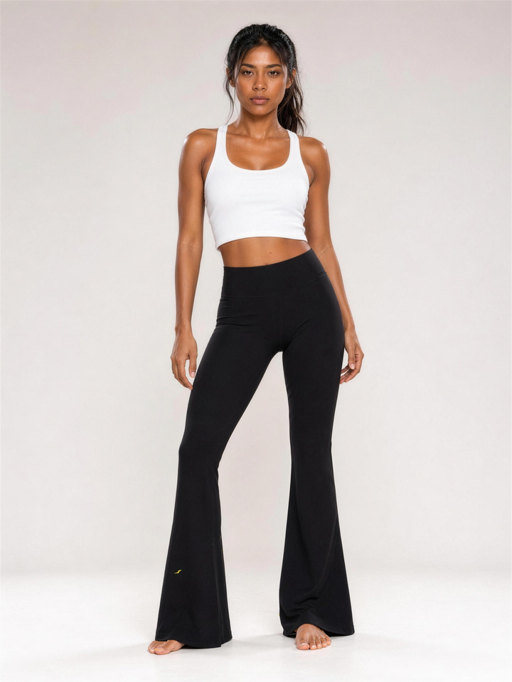Woman wearing HIVOLT High-Waisted Flare Leggings, studio shot